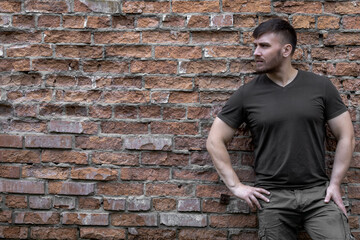 Bearded man on a background of a brick wall.