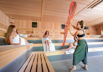 Traditional sauna ritual performed for group of females in spa center