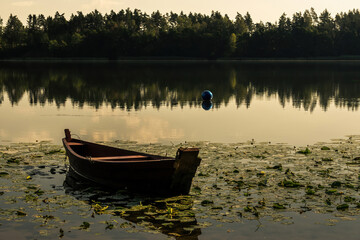 a boat on the lake in Masuria in Poland after sunset