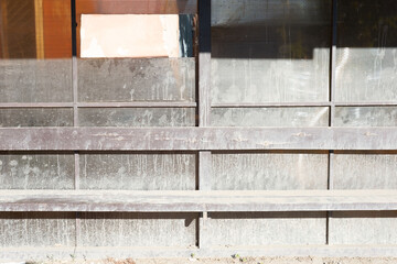 a dirty bus stop smeared with whitewash stains. Deserted station, wooden stop, bench