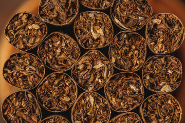 Pile of new cigars close up on wooden table