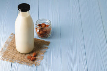 Obraz na płótnie Canvas Almond milk with almond nuts in glass