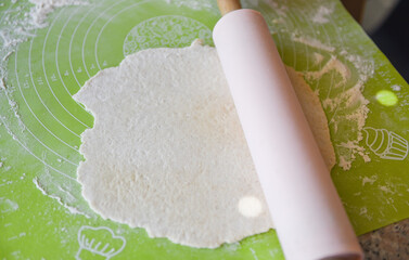 prepares the dough and rolling pin with flour on board - hands knead the dough homemade pastry for bread or pizza Bakery background
