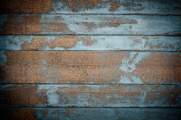 Natural wooden background of six brown boards covered with in places of blue paint