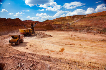 Aluminium ore mining and transporting. Bauxite clay quarry (mine). Excavator loads ore to Hitachi dump truck. Blue sky with light clouds. Arkalyk, Kazakhstan. © Alexey Rezvykh