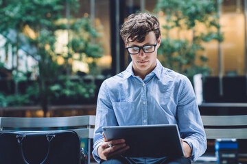 Clever Caucasian trader checking money transfer information on financial website connected to 4g...