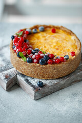 Cheesecake cake with berries. Cake with delicate curd and dough base. High quality photo.