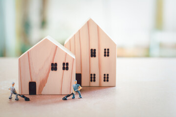 Home repair and inspector concept. Wooden home and blurry miniature or small technician fix and checking the house and real estate with copy