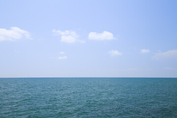 Beautiful calm sea and blue sky with white clouds.