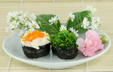 sushi,Japanese food put on the white dish on plate the bamboo.