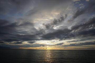 Sunset. Beautiful sunset at Japanese sea. Gold cloudy sky sunset. Picture Sea sunset.