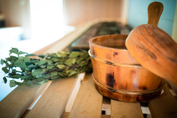Sauna accessories laying on wooden bench