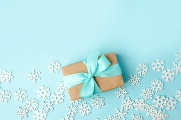 Happy New 2020 year concept, goft or present box with tissue bow and white snowflakes on blue background, copy space, xmas, christmas winter holiday creative card, banner, flyer, promotion voucher