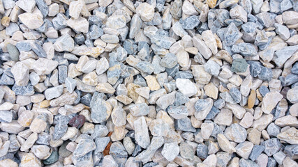 Beautiful background from multi-colored gravel and pebbles. Natural stone chips for decorating flower beds and garden paths.