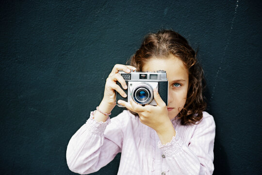 Spanish girl with brown hair and blue eye taking a photo