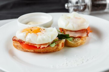 Sandwich with egg tomato and bacon. A delicious breakfast