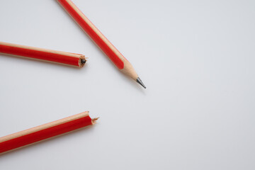 
A pencil broken in half and a pencil not broken