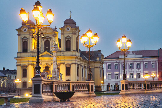 The rainy evening and night city lights on the Unirii Square of Timisoara, Romania