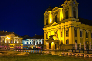 Fototapeta na wymiar The rainy evening and night city lights on the Unirii Square of Timisoara, Romania