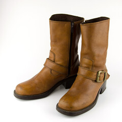 A pair of brown leather boots on a white background.