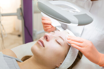A professional beautician performs a mechanical facial cleansing procedure at the spa. Beautiful...