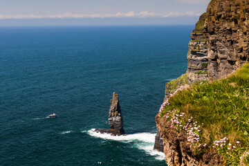 Photo capture of a breathtaking natural nature landscape. Cliffs of Moher with tourist boat , wild atlantic way. Ireland. Europe