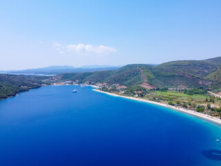 Fototapeta na wymiar Luxury yacht sailing in blue sea surrounded with coast 