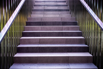 Modern concrete stairs with metal handrails