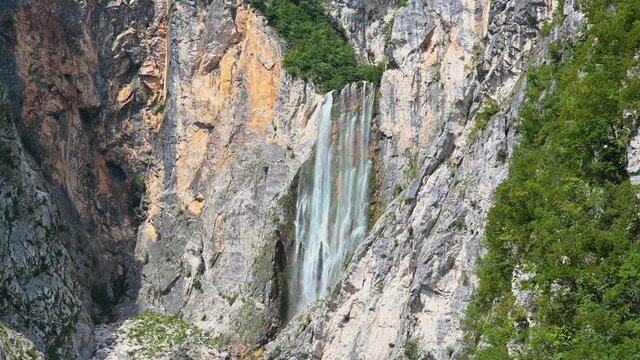 Waterfall Boka, Slovenia. One of most beautiful waterfalls in Julian Alps. Water gently flowing down the rocks. Static, wide shot, 4K