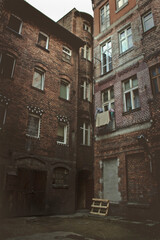 small gloomy courtyard with old houses. Urban architecture