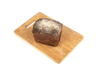 Top view of a loaf of rye bread on a wooden cutting board.
