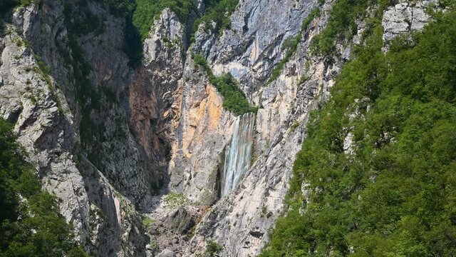 Waterfall Boka, Slovenia. One of most beautiful waterfalls in Julian Alps. Water gently flowing down the rocks. Static, wide shot, 4K