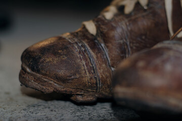Close up of a pair of old worn out football boots