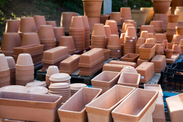 Different clay pots for garden or greenhouse plants stacked in garden supplies store
