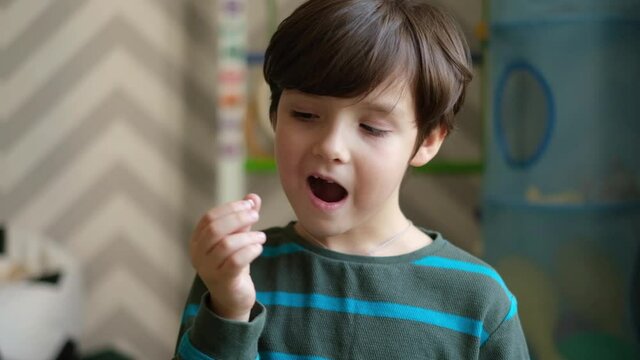 A small handsome boy shows that his milk teeth have fallen out. The concept of changing teeth in children