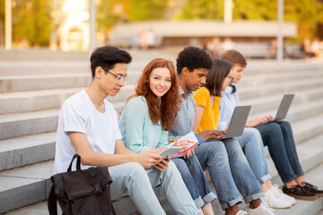 Students Learning Preparing For Exams Sitting On College Steps Outdoor