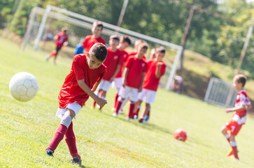 Young boy shooting soccer ball