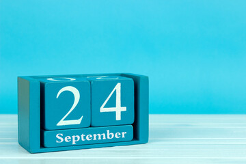 wooden calendar with the date of August 24 on a blue wooden background, World Day Against Software Patents, World Maritime Day, International Caravan Day	