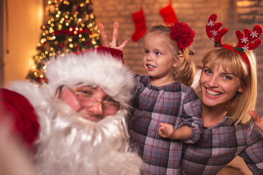 Mother and daughter taking a selfie with Santa