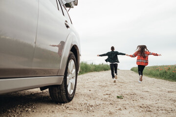 Young Beautiful Couple Having Fun Near the Car, Travel and Roadtrip Concept