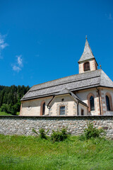 Fototapeta na wymiar Parish church of San Vito, a small village at the foot of the Dolomites towards Lake Braies. Alps. South Tyrol. Italy