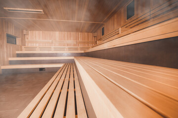 Empty interior of huge sauna in classic wooden finish