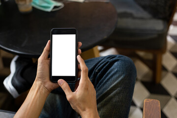 man hand using smartphone In the coffee shop,Screen blank with clipping path