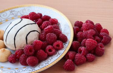 Pastry with raspberries on a white plate. Ripe berries.