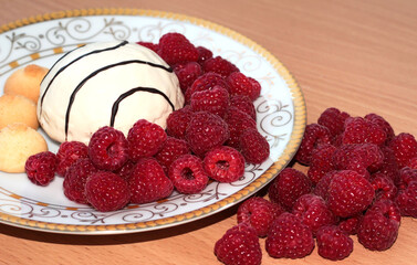 Pastry with raspberries on a white plate. Ripe berries.