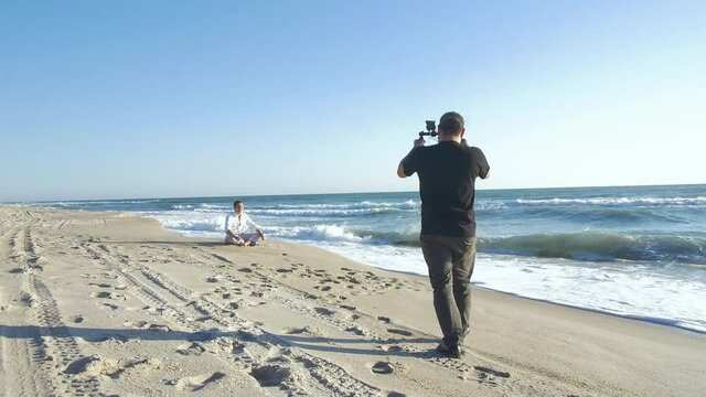 345 Cameraman recording a subject by the beach