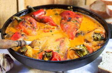 Sweet peppers in tomato and sour cream sauce, a traditional dish in some European countries. Rustic style.