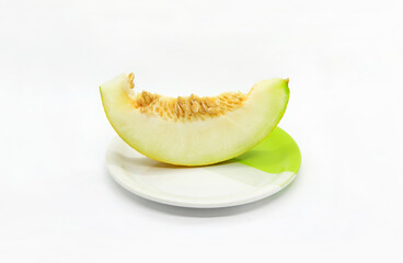 Piece of ripe melon with seeds on a plate