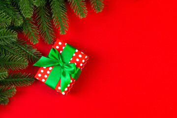 Top view of colorful holiday background made of fir tree and gift box. Happy New Year concept with copy space