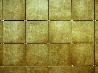 Wall  made of yellow square tiles